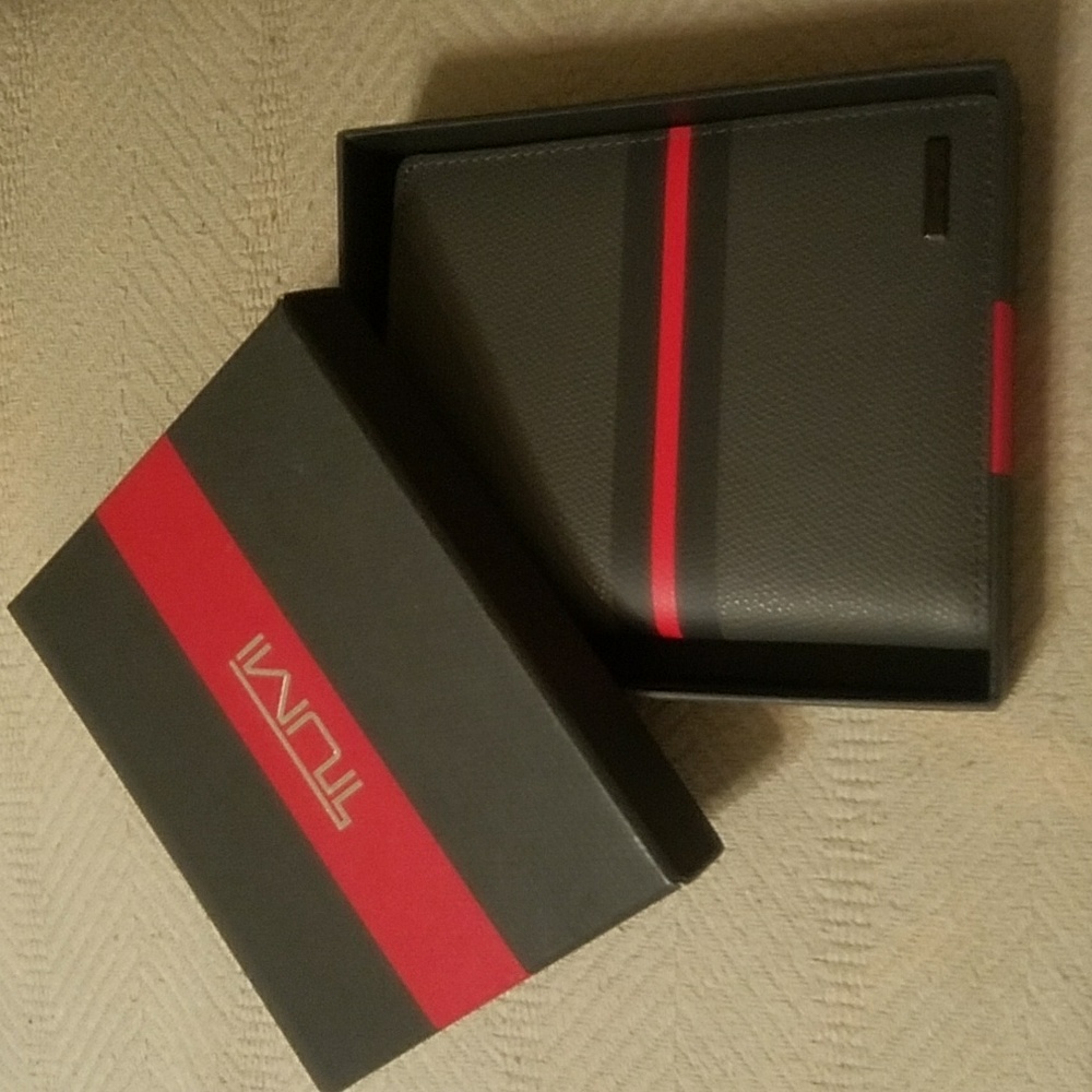 Tumi passport case in grey with red stripe